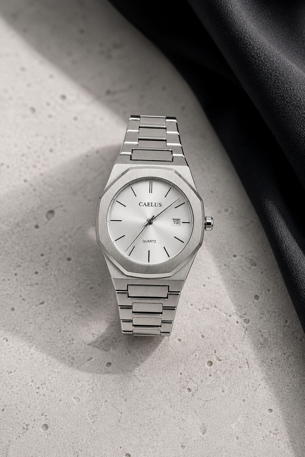 CAELUS Model 02 white dial watch vertically aligned on pale stone